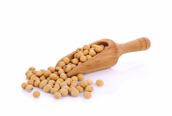 Soybeans in wooden spoon isolated on white background.