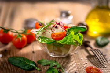 Fresh vegetable salad on wooden background