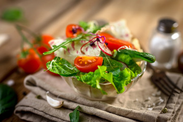Fresh vegetable salad on wooden background