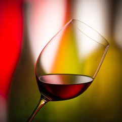 glass with red wine bottle