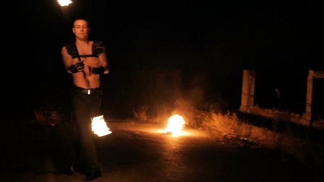 man performs a trick with fire