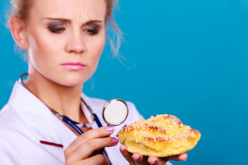 dietitian examine sweet roll bun with stethoscope