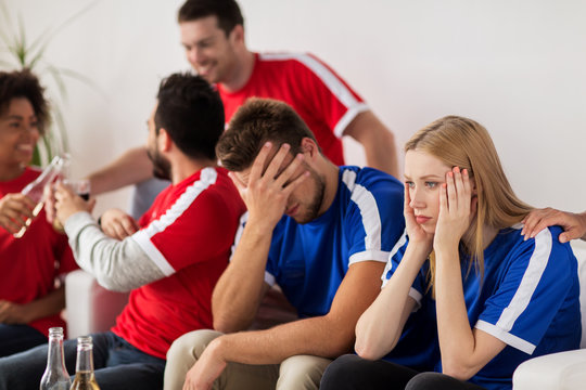 friends or football fans watching soccer at home