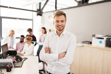 Fototapeta premium happy young man over creative team in office