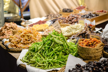 Colorful variety dry fruits and nuts in the street shop vibrant background