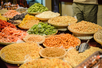 Colorful variety dry fruits and nuts in the street shop vibrant background