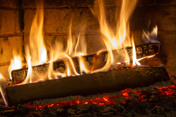 Burning firewood in the fireplace close up