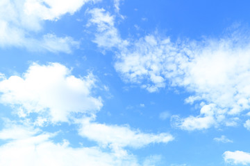 Naklejka na ściany i meble Clear white fluffy clouds in a blue sky. Sky background with blank space for text.
