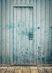 Green dirty and wooden door with foreground