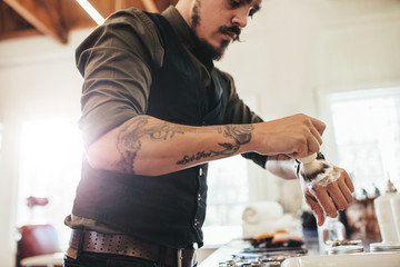 Hairstylist preparing the shaving foam