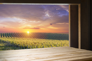 Red wine with barrel on vineyard in green Tuscany, Italy