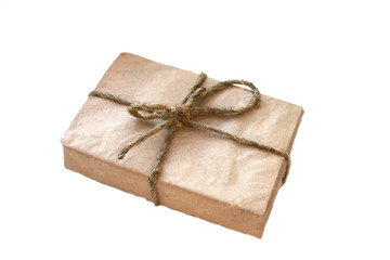 gift box wrapped in paper and wrapped with rope on a white background clouded sky