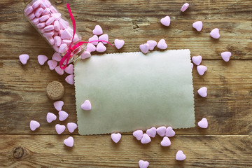 vial with small pink candy heart shape, empty paper