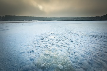 Frozen water reservoir on fields. Winter landscape.