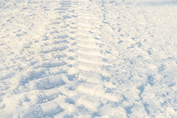 Fototapeta na wymiar Car Tracks In Fresh White Snow