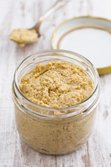 homemade mustard in a glass jar, top view