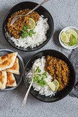 Cream coconut lentil curry with rice and naan bread - vegetarian lunch. Top view, flat lay. Vegetarian healthy food concept