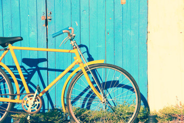 Yellow old vintage leaning on vintage wall background in the sun.