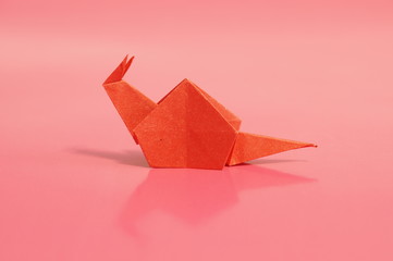 Paper origami snail isolated on a colorful background