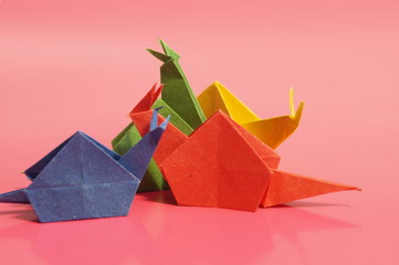 Paper origami snail isolated on a colorful background © romanklevets