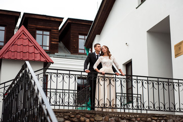 gorgeous happy wedding couple walking and kissing in the old city of Minsk, Belarus
