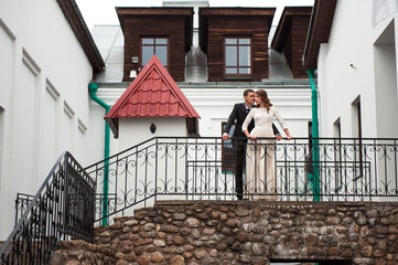 gorgeous happy wedding couple walking and kissing in the old city of Minsk, Belarus