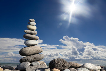 Zen stones on the beach with sun light