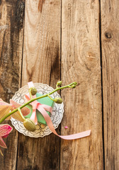 A gift on a white napkin andorchidea on the wooden background