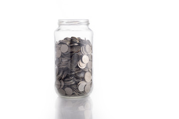 Isolated coin in glass jar