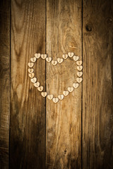 Valentine`s day. Нeart from buttons on a wooden background