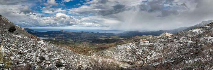 Fototapeta na wymiar Panoramic view of snow on mountain village of Speloncato in Cors