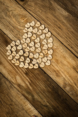 Naklejka premium Valentine`s day. Нeart from buttons on a wooden background