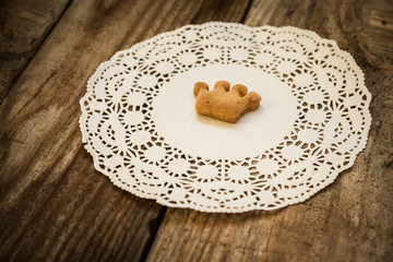 cookies in the shape of a crown on a white napkin on a wooden table