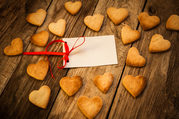 On the White Isolated Letter and Gingerbread Cookies in the Shape of Heart at Valentine Day. On the wooden background
