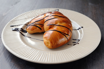 Tasty croissant on the white plate