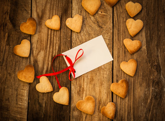 On the White Isolated Letter and Gingerbread Cookies in the Shape of Heart at Valentine Day. On the wooden background