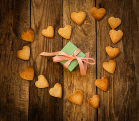 Gift and  Cookies in the Shape of Heart at Valentine Day. On the wooden background