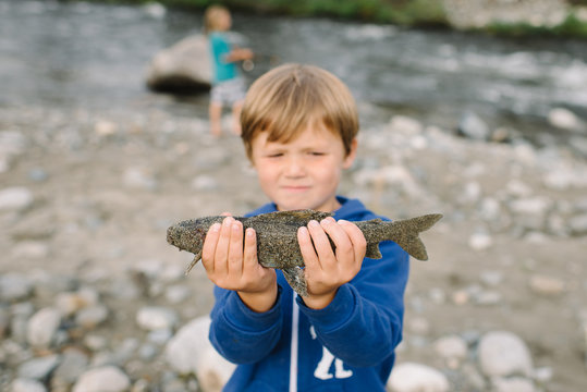 Boy holding fish at national park