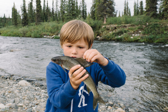 Boy holding fish at national park