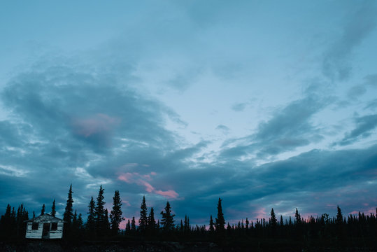 Cabin and woodland at dusk, National Park, Alaska, North America 