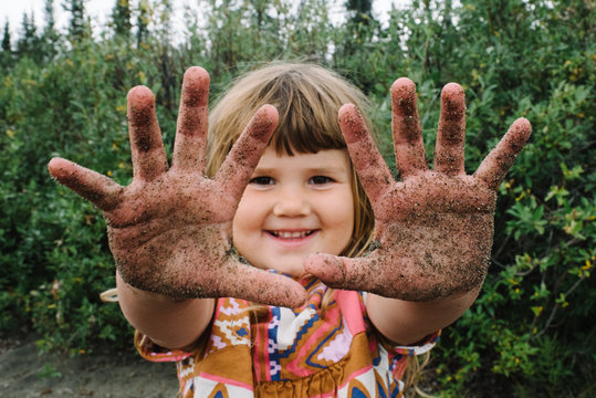 Portrait of young girl with dirty hands, National Park, Alaska, North America 