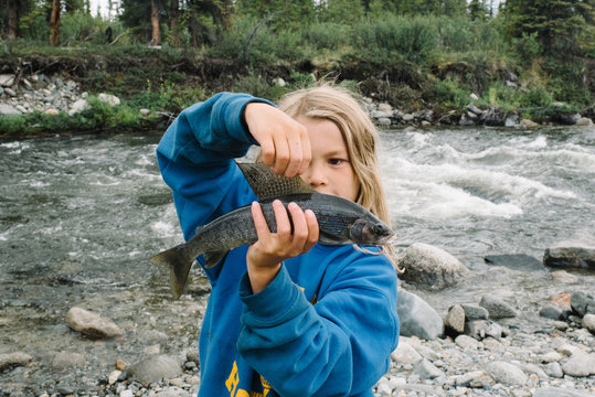Girl holding fish at national park