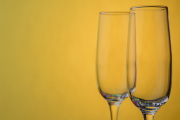 Glasses of champagne on a yellow background