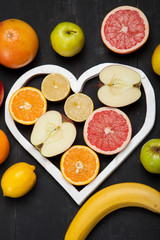Vegetarian. Fruits and heart on black background
