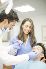 Fototapeta na wymiar Young man having dental chekup at dentist office