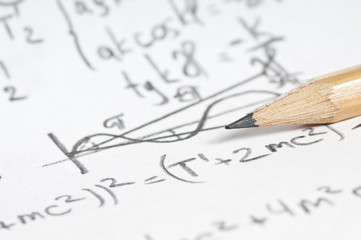 sheet of paper filled with calculations of nuclear and quantum p