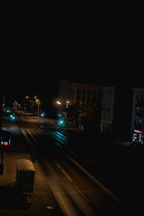 Fototapeta na wymiar night city life: car on the road and street lamps