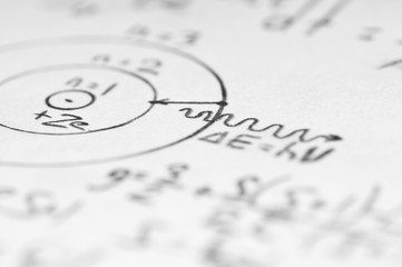 sheet of paper filled with calculations of nuclear and quantum p