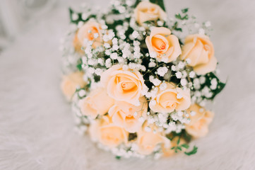 Bouquet of yellow roses and wedding rings