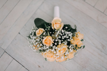 Bouquet of yellow roses and wedding rings